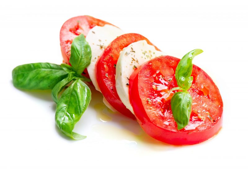 Caprese Salad. Tomato and Mozzarella slices with basil leaves